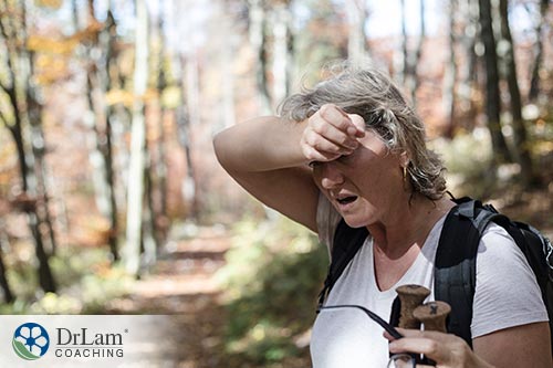An image of a fatigued woman trying to hike