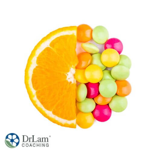 An image of half an orange slice and colorful tablets