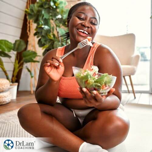 An image of a woman eating salad