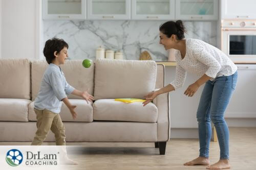 An image of a mom and a kid playing a ball