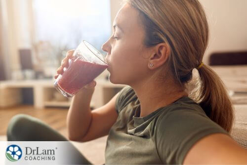 An image of a woman drinking strawberry smoothie