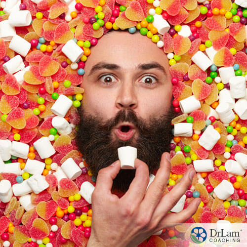 An image of a bearded man buried in candy and marshmallows