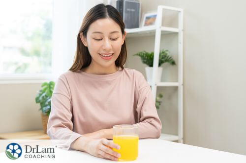 An image of a woman drinking orange juice