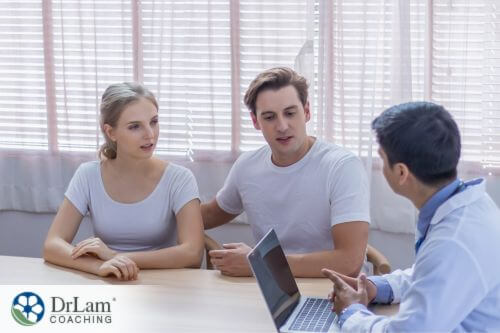 An image of a man and woman consulting with a doctor
